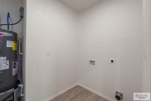 861 Rio Grande St, San Benito, TX 78586 - clothes washing area featuring electric dryer hookup, water heater, washer hookup, and light wood-type flooring