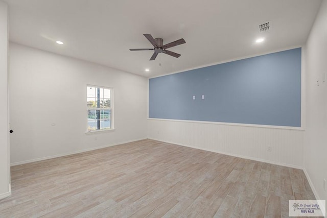 861 Rio Grande St, San Benito, TX 78586 - spare room with ceiling fan, wood finished floors, a wainscoted wall, and recessed lighting