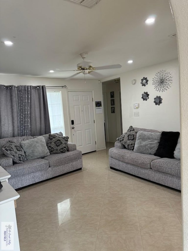 living room with light tile patterned floors and ceiling fan