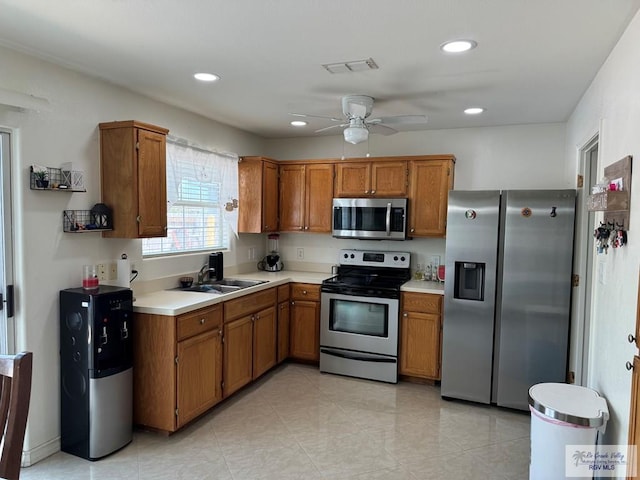 kitchen featuring ceiling fan, sink, and stainless steel appliances