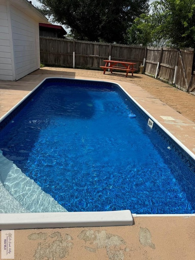 view of swimming pool with a patio