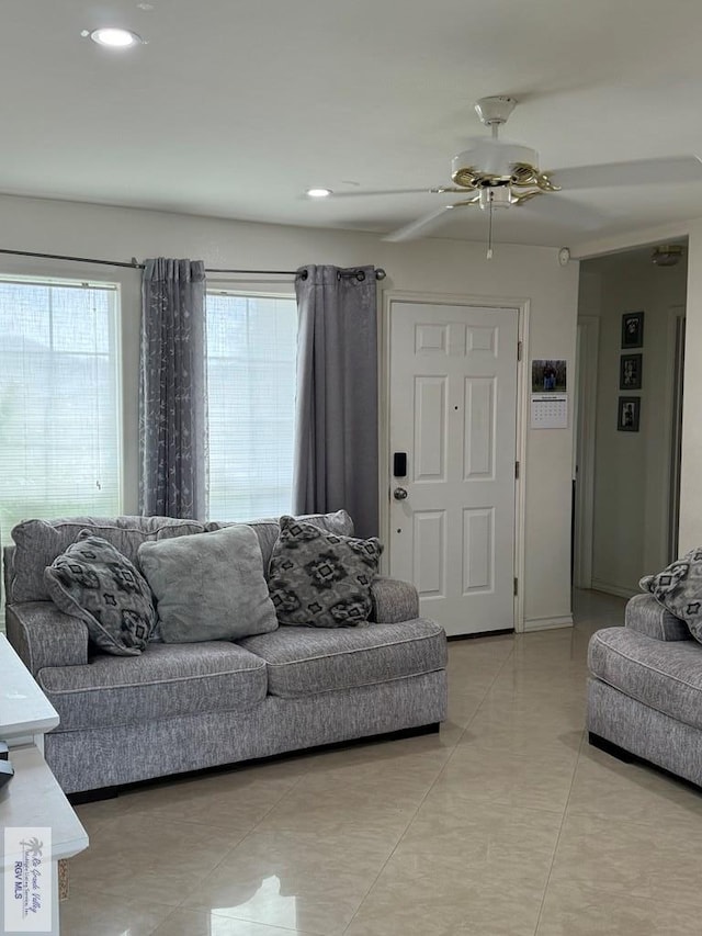 tiled living room featuring ceiling fan