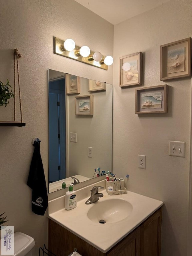 bathroom featuring vanity and toilet