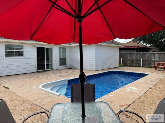 view of swimming pool featuring a patio area