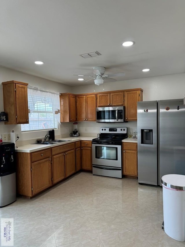 kitchen with ceiling fan, sink, and appliances with stainless steel finishes