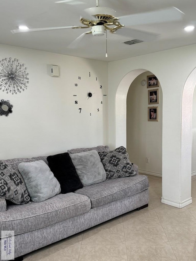 tiled living room with ceiling fan