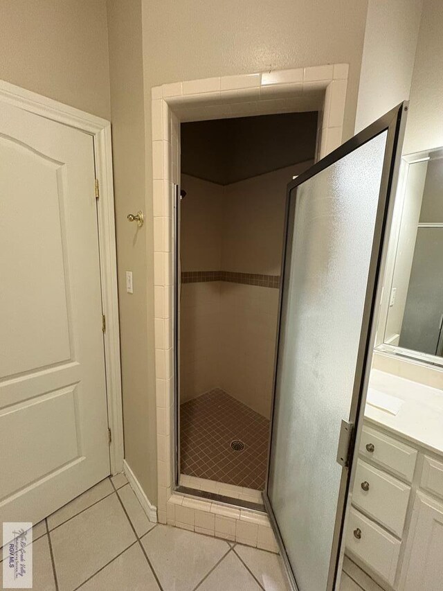 901 Plantation St, Brownsville, TX 78526 - bathroom featuring tile patterned flooring, a shower stall, and vanity