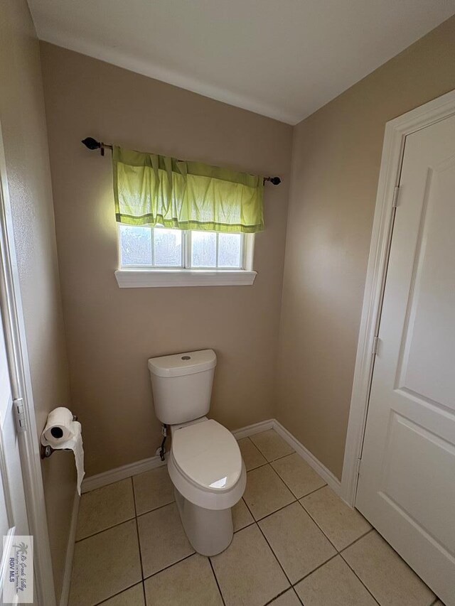 901 Plantation St, Brownsville, TX 78526 - bathroom featuring toilet, tile patterned floors, and baseboards