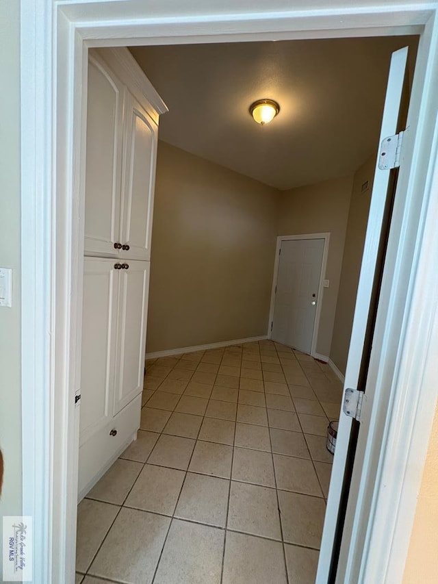 901 Plantation St, Brownsville, TX 78526 - hallway featuring light tile patterned flooring and baseboards