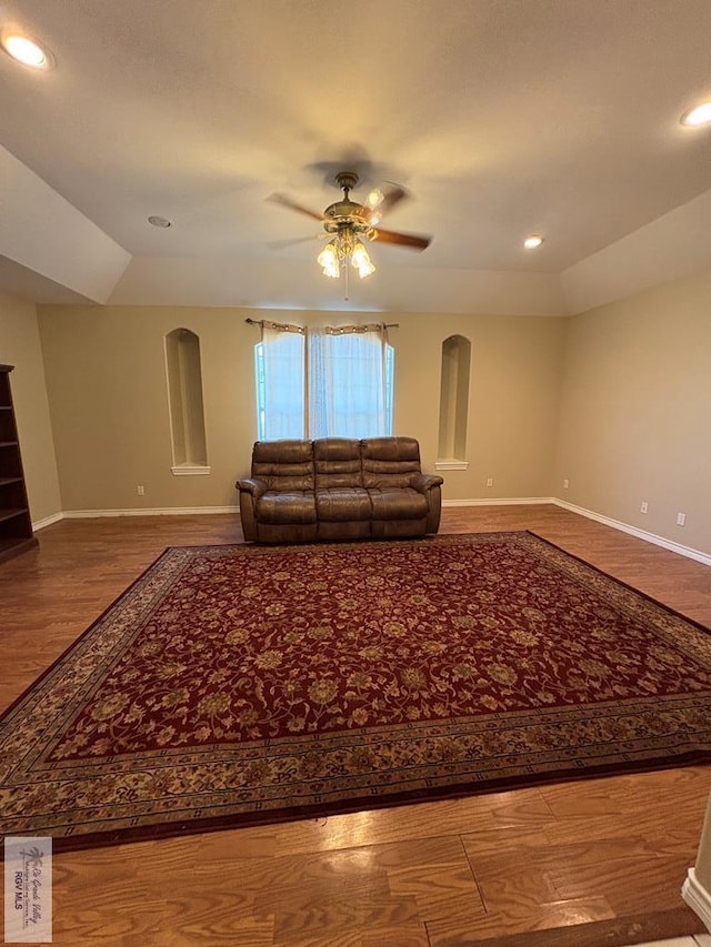 901 Plantation St, Brownsville, TX 78526 - living room featuring arched walkways, ceiling fan, baseboards, wood finished floors, and recessed lighting