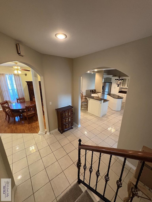 901 Plantation St, Brownsville, TX 78526 - stairway with arched walkways, tile patterned flooring, baseboards, a ceiling fan, and recessed lighting