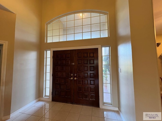 901 Plantation St, Brownsville, TX 78526 - foyer entrance featuring light tile patterned floors, baseboards, and a towering ceiling