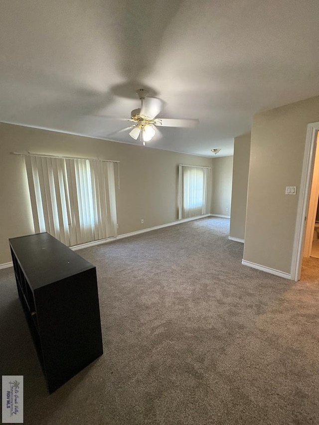 901 Plantation St, Brownsville, TX 78526 - unfurnished living room with a ceiling fan, baseboards, and carpet