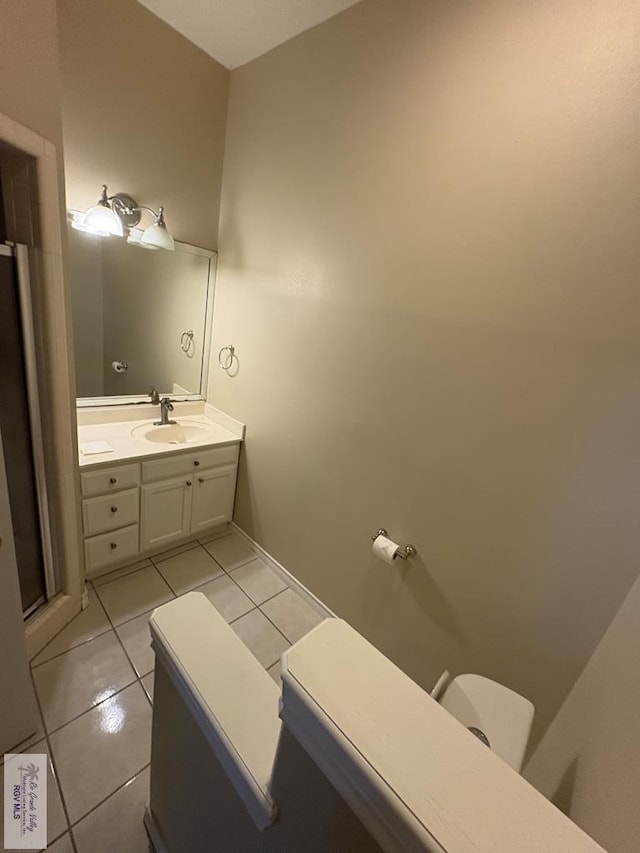 901 Plantation St, Brownsville, TX 78526 - bathroom with vanity, tile patterned floors, toilet, and a stall shower