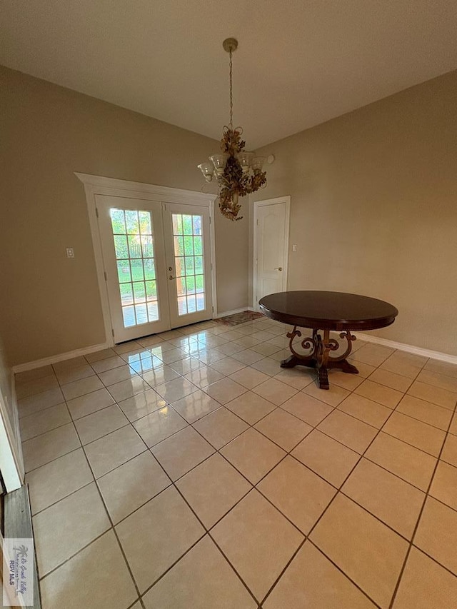 901 Plantation St, Brownsville, TX 78526 - unfurnished dining area featuring a chandelier, light tile patterned flooring, baseboards, and french doors