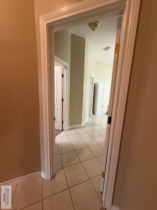 901 Plantation St, Brownsville, TX 78526 - hallway with light tile patterned floors and baseboards
