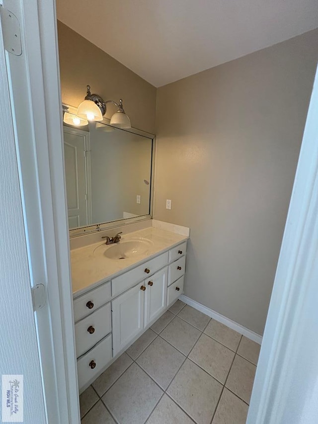 901 Plantation St, Brownsville, TX 78526 - bathroom featuring vanity, tile patterned flooring, and baseboards