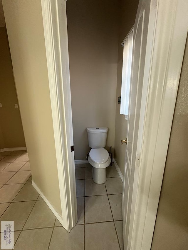 901 Plantation St, Brownsville, TX 78526 - bathroom featuring tile patterned floors, toilet, and baseboards