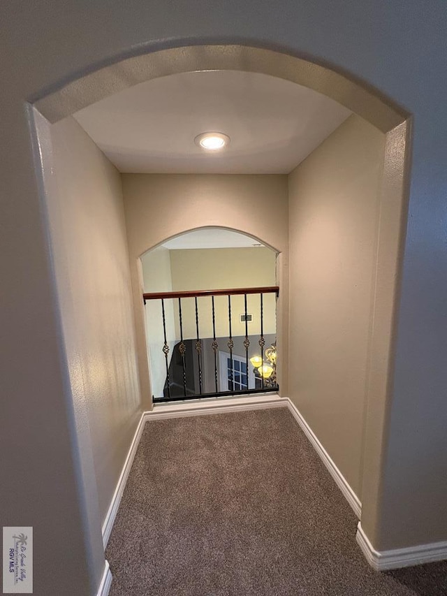 901 Plantation St, Brownsville, TX 78526 - hallway with arched walkways, carpet, and baseboards