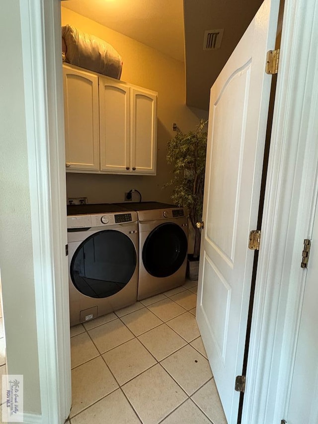 901 Plantation St, Brownsville, TX 78526 - washroom featuring washing machine and dryer, cabinet space, and light tile patterned floors