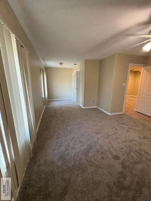 901 Plantation St, Brownsville, TX 78526 - spare room with carpet floors, baseboards, a ceiling fan, and arched walkways