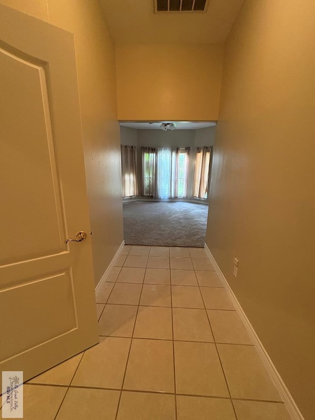 901 Plantation St, Brownsville, TX 78526 - corridor with tile patterned floors, baseboards, carpet, and a high ceiling