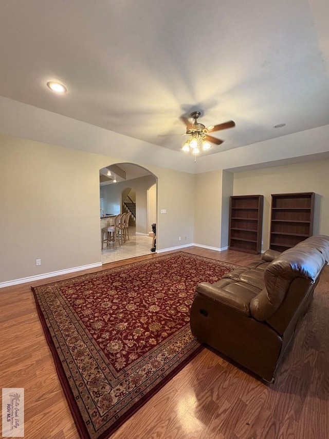 901 Plantation St, Brownsville, TX 78526 - living room with arched walkways, wood finished floors, a ceiling fan, baseboards, and recessed lighting