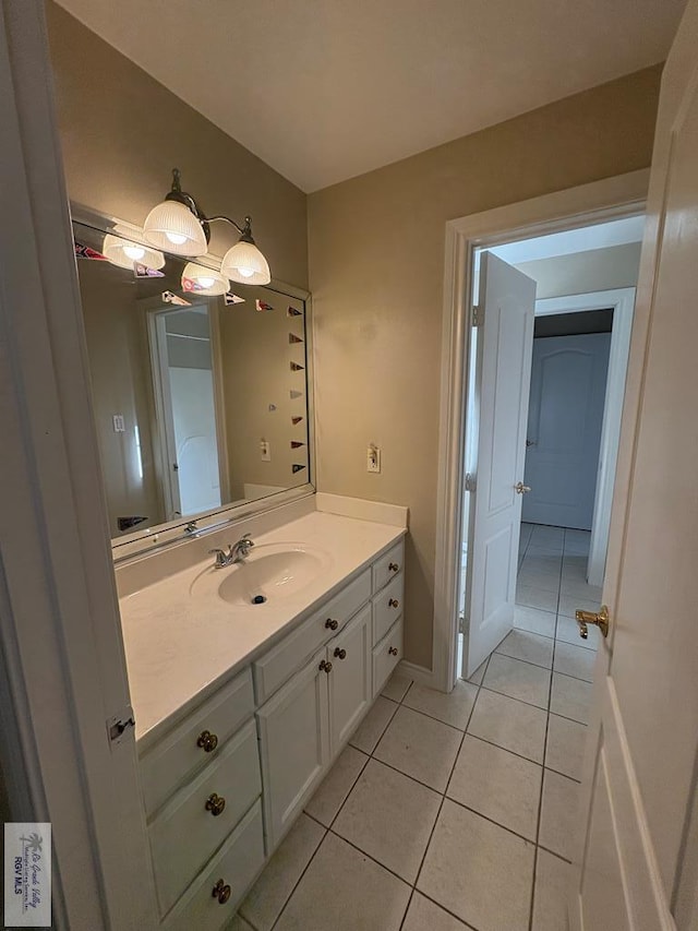 901 Plantation St, Brownsville, TX 78526 - bathroom with tile patterned floors and vanity