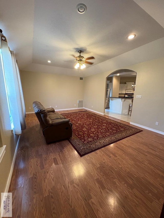 901 Plantation St, Brownsville, TX 78526 - living area featuring wood finished floors, arched walkways, ceiling fan, baseboards, and recessed lighting