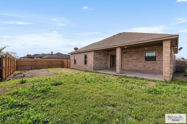 back of house with a patio area and a yard