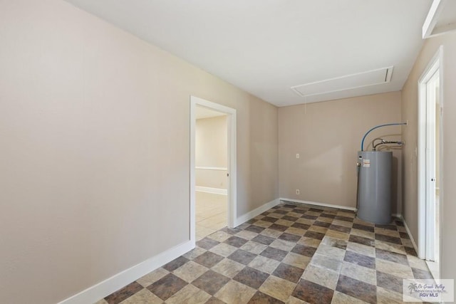 2805 Swiss Pine Ct, Harlingen, TX 78550 - empty room with attic access, water heater, and dark tile patterned flooring