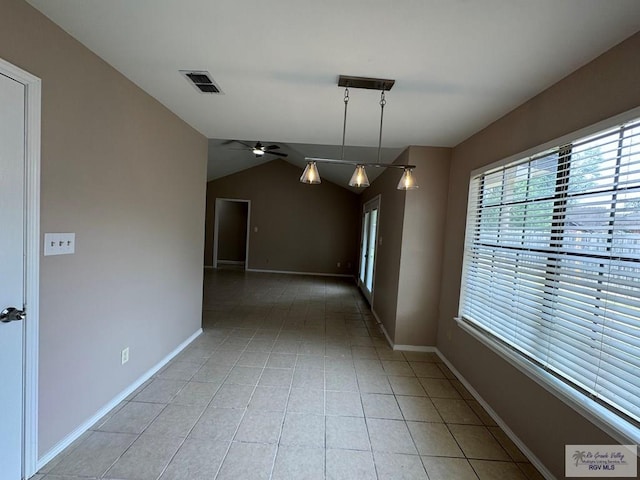 2805 Swiss Pine Ct, Harlingen, TX 78550 - unfurnished room featuring a ceiling fan, light tile patterned floors, vaulted ceiling, and baseboards
