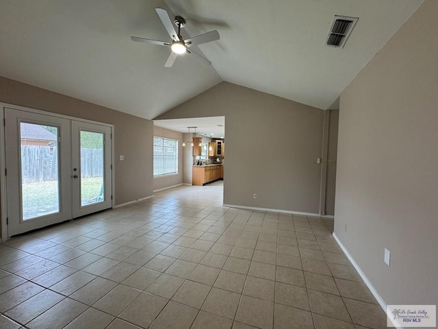 2805 Swiss Pine Ct, Harlingen, TX 78550 - unfurnished living room featuring a ceiling fan, french doors, lofted ceiling, light tile patterned flooring, and baseboards