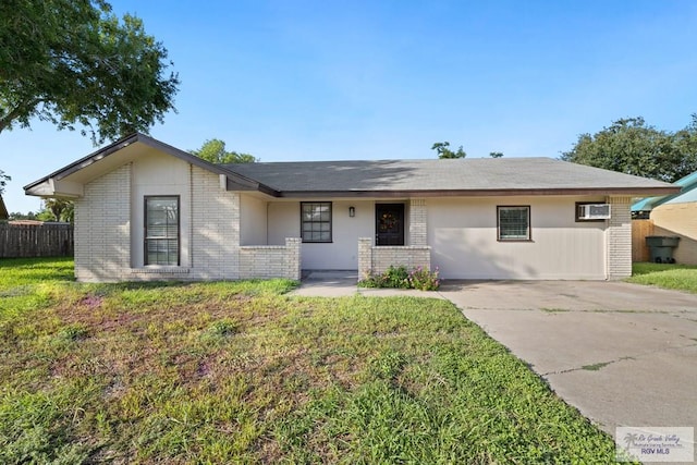 2805 Swiss Pine Ct, Harlingen, TX 78550 - ranch-style house featuring brick siding, concrete driveway, and a wall mounted air conditioner