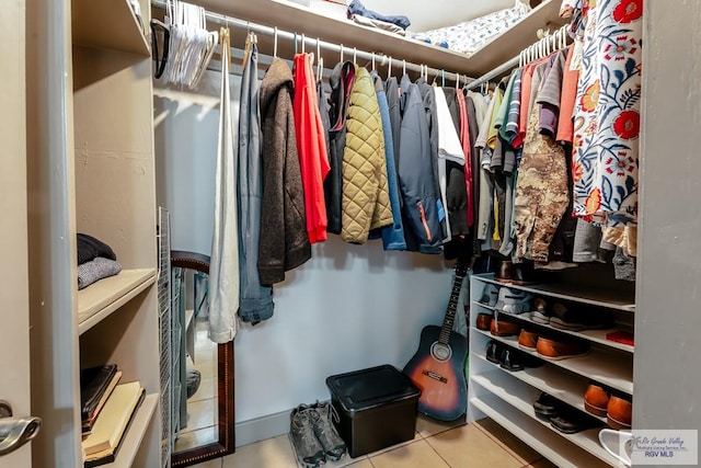 spacious closet featuring tile patterned flooring