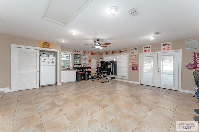 interior space with ceiling fan, a healthy amount of sunlight, light tile patterned floors, and french doors