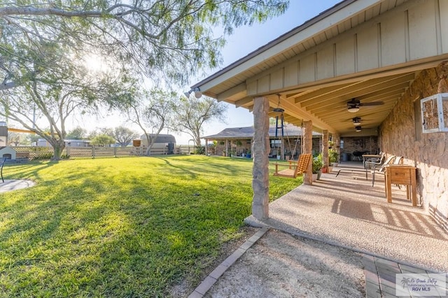 view of yard featuring a patio and ceiling fan