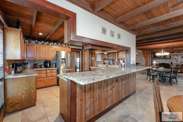 kitchen with beamed ceiling, wooden ceiling, stainless steel refrigerator with ice dispenser, and an inviting chandelier