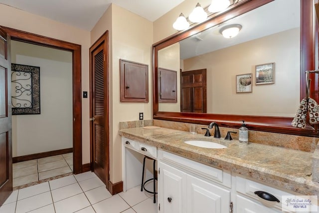 bathroom with tile patterned floors and vanity