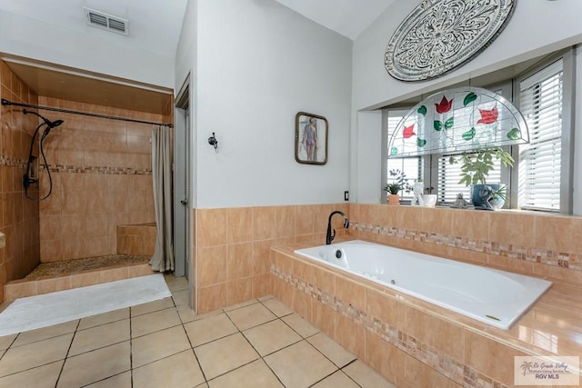 bathroom with separate shower and tub and tile patterned flooring