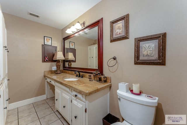 bathroom with tile patterned floors, vanity, and toilet