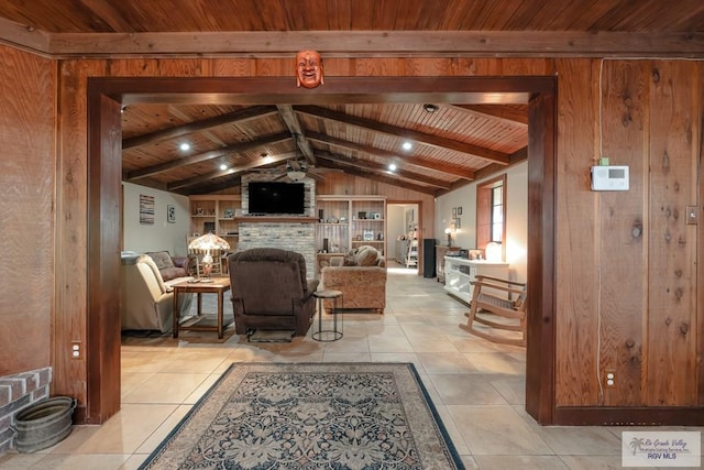 tiled living room with vaulted ceiling with beams, wood walls, wood ceiling, and a fireplace