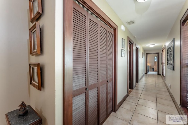 hall featuring light tile patterned flooring