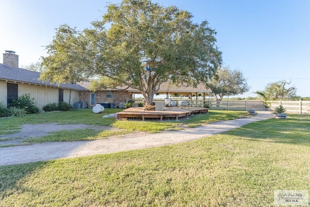 surrounding community with a lawn and a wooden deck