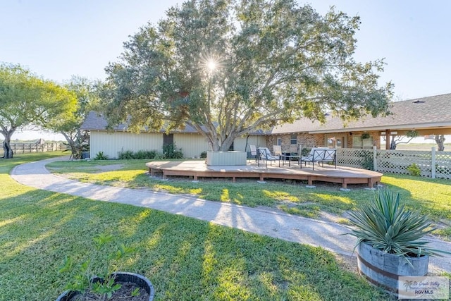 view of dock featuring a wooden deck and a yard