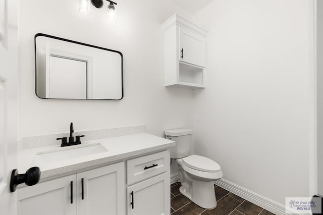 bathroom featuring hardwood / wood-style floors, vanity, and toilet