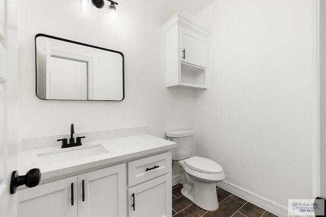 bathroom featuring hardwood / wood-style floors, vanity, and toilet
