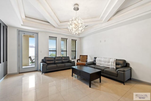 living room with a notable chandelier, a raised ceiling, and light tile patterned floors