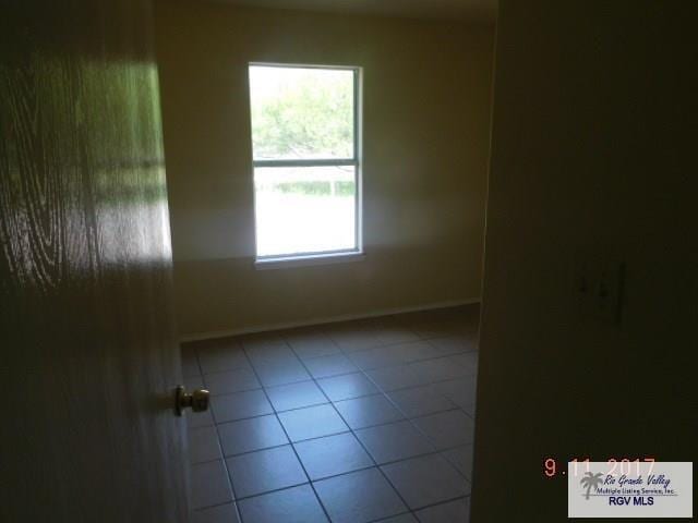 2100 Old Port Isabel Rd, Brownsville, TX 78526 - tiled empty room with baseboards