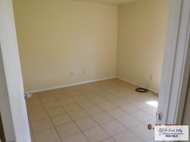 2100 Old Port Isabel Rd, Brownsville, TX 78526 - spare room featuring light tile patterned floors and baseboards